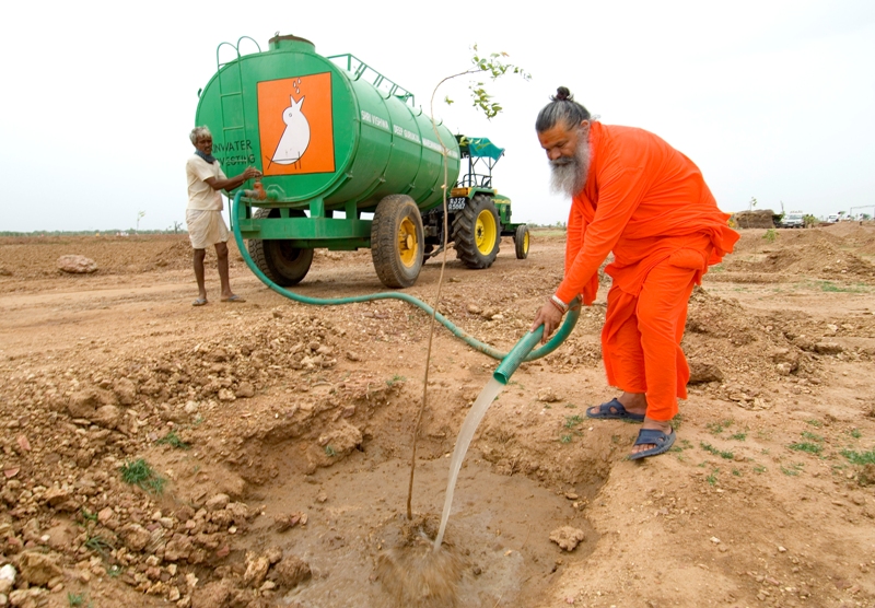 Swamiji watering tree